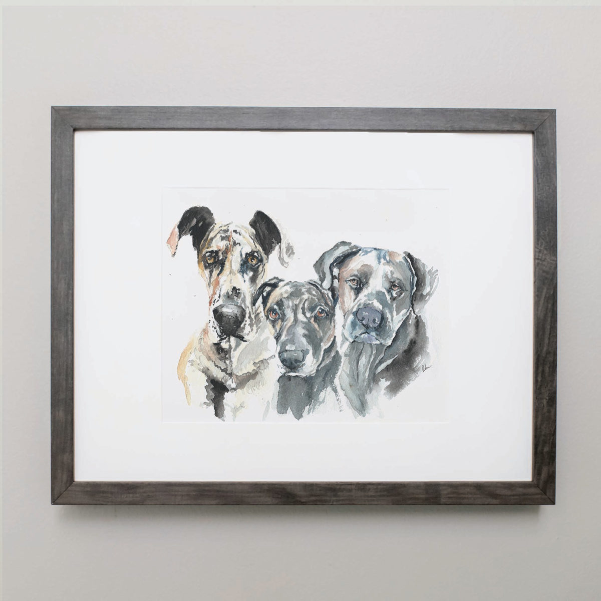 Watercolor of three dogs in a gray frame