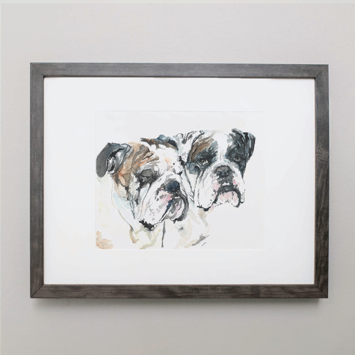 Watercolor of two bulldogs in a gray frame