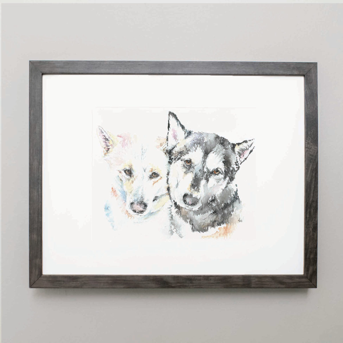 Watercolor of two huskies in a gray frame