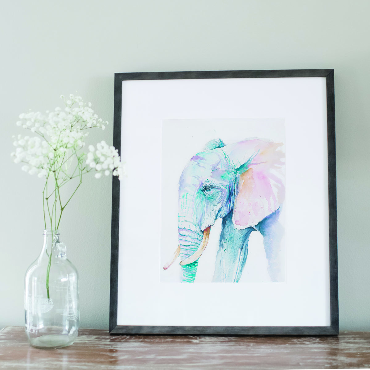 Watercolor of blue elephant in gray frame