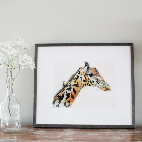 Watercolor of a giraffe framed next to flowers