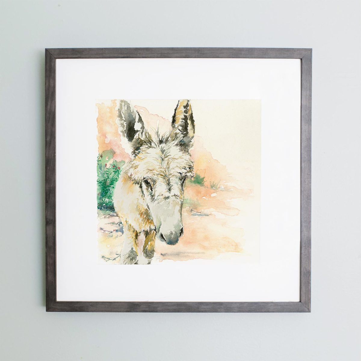 Watercolor of a donkey in Petra in a gray frame