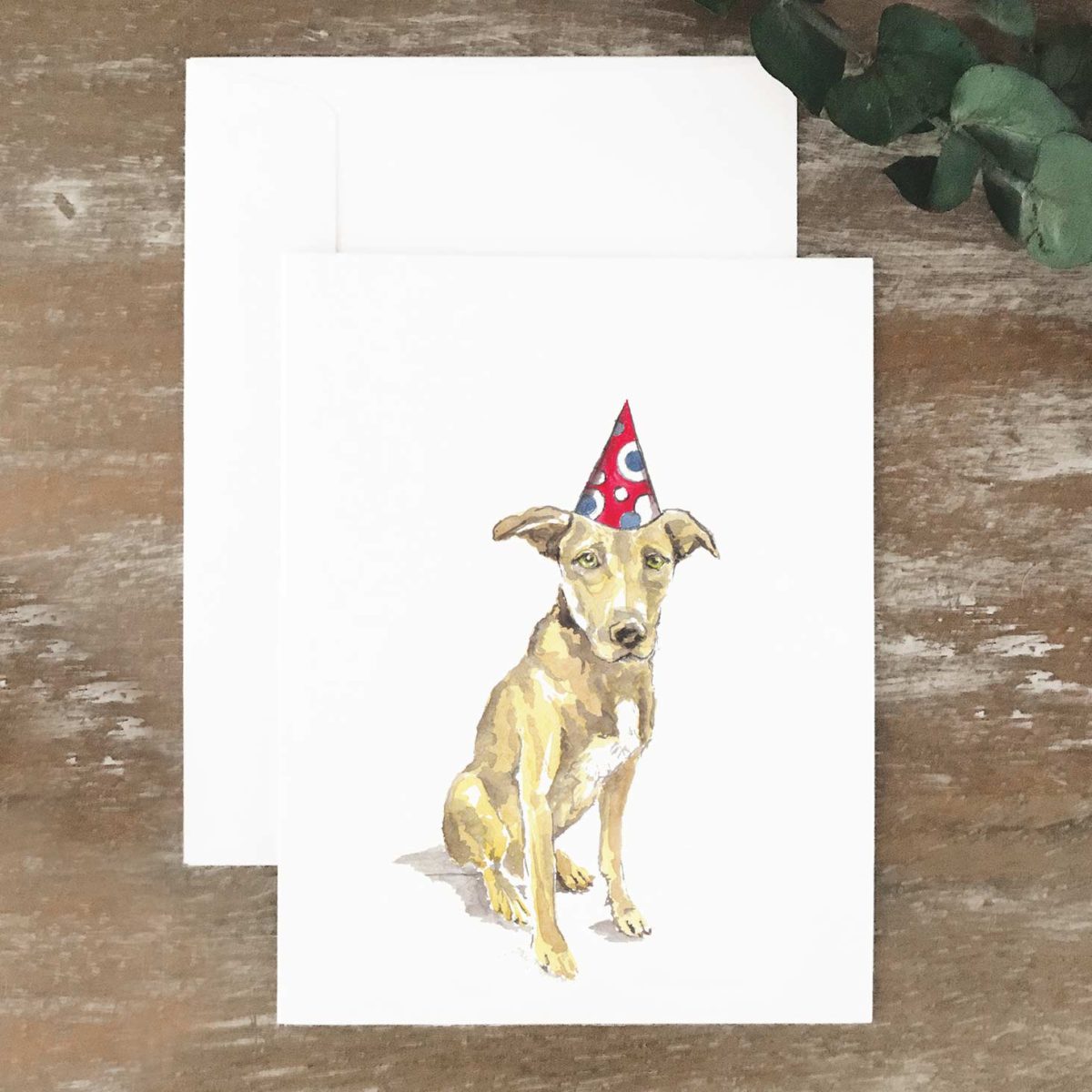 A2 greeting card of a tan dog wearing a party hat