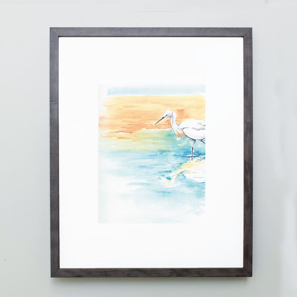 Watercolor of snowy egret on beach in gray frame