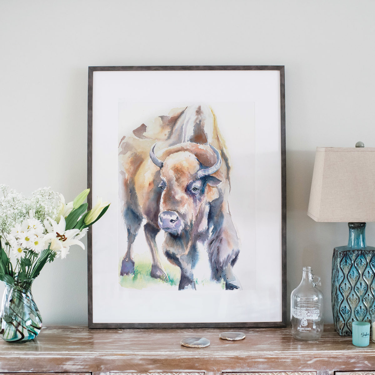 Watercolor of American bison in gray frame and styled with flowers