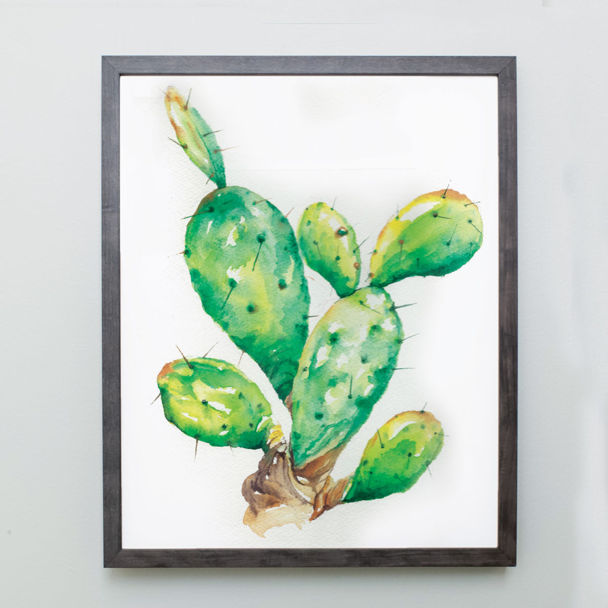 Watercolor of prickly pear cactus in a gray frame